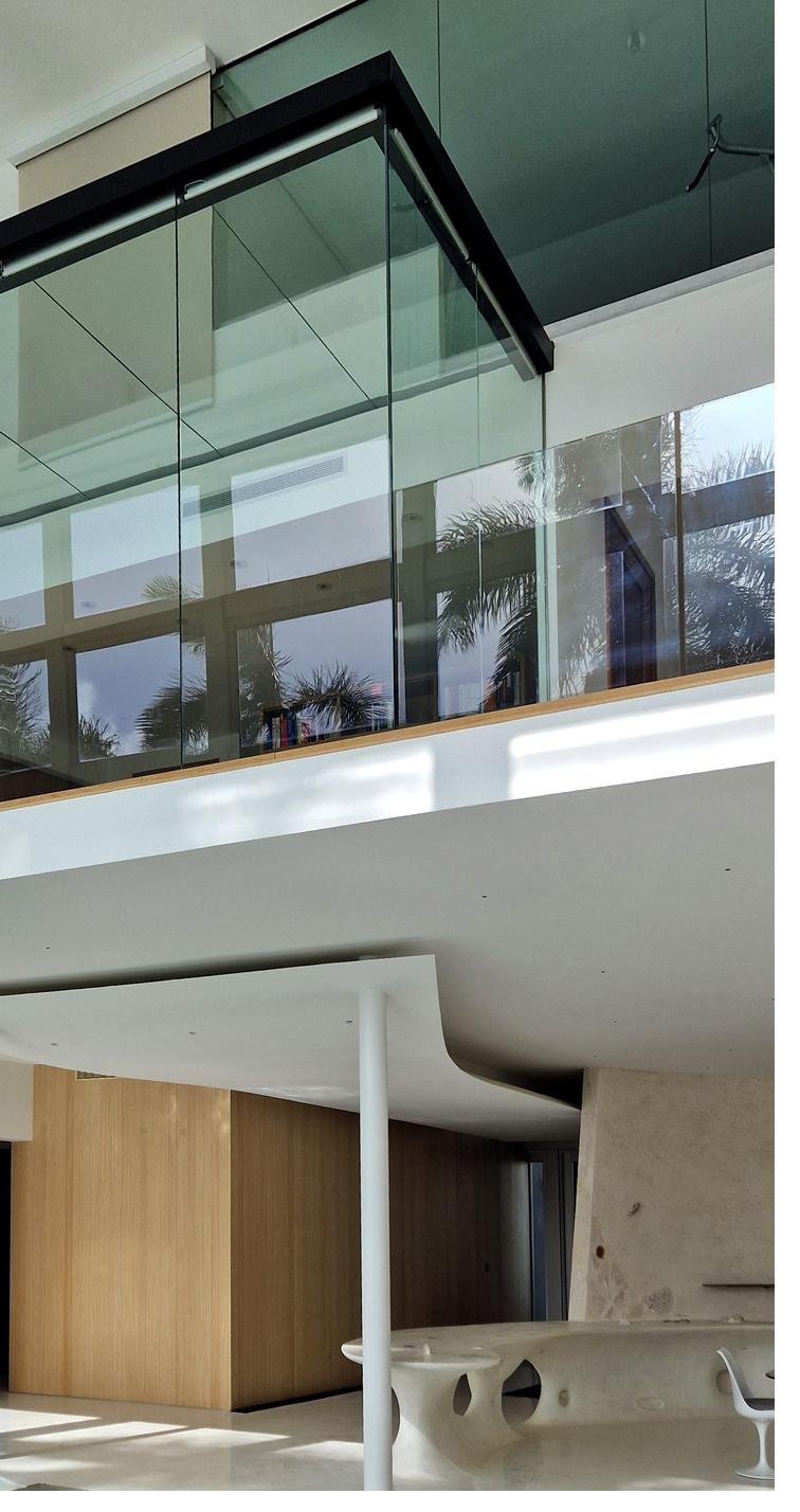 Modern glass staircase and living room detail